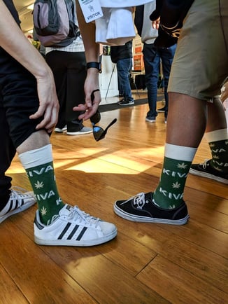 Custom socks for cannabis industry Budtenders wearing Kiva Confections socks at dispensary
