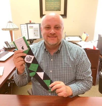 teacher holding custom green argyle socks