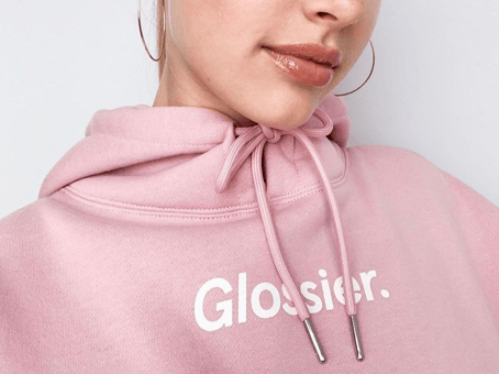 girl in glossier pink hoodie